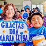 Madre con su hijo sonríen con los beneficios recibidos