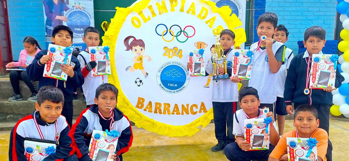 Niños sonrientes posan con las medallas, el trofeo y los regalos