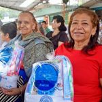 Adultos mayores sonrientes con su kit de aseo