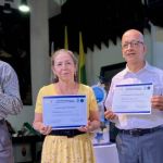 Junto a sus diplomas, tres participantes lo exponen con orgullo