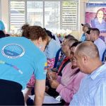 Generando un ambiente ded sonrisas y complicidad, voluntaria con actitud servicial asiste a beneficiarios en el desarrollo de las actividades de valores